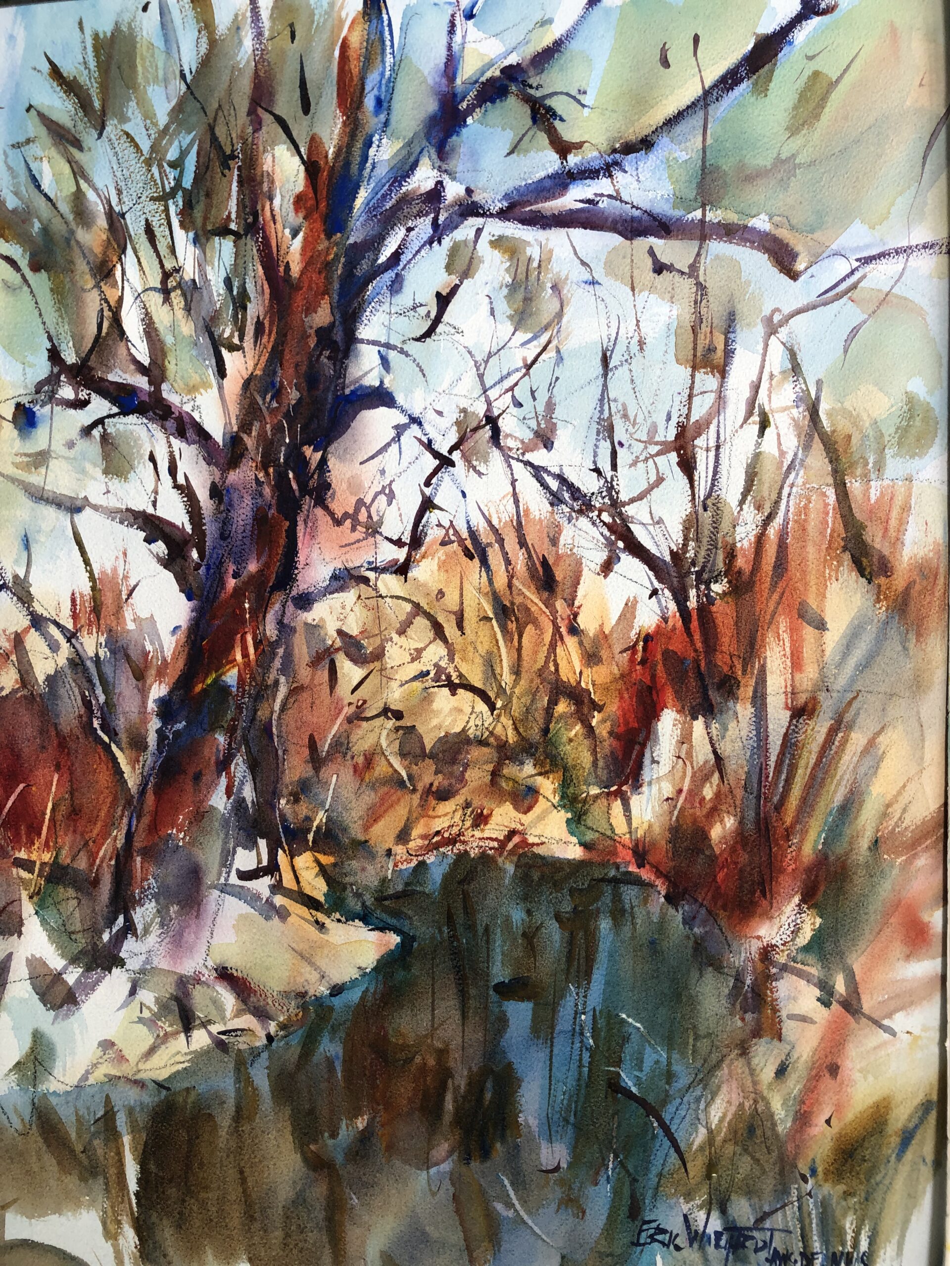 An expressive watercolor painting in warm colors depicting a wooded stream scene. Loose, gestural brushstrokes create the dark, stylized tree branches against a light background, with strong russet and orange tones in the middle ground foliage, and dark blue-green water.