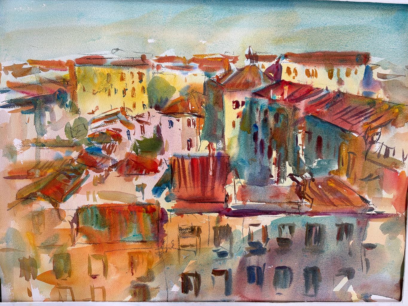 An impressionistic watercolor of a European-style cityscape seen from an elevated view. The painting features a cluster of buildings with terracotta roofs, rendered in warm oranges, reds, and yellows. The structures are defined by loose, dark gestural lines, while the sky and distant buildings fade into soft blue and pale green washes.