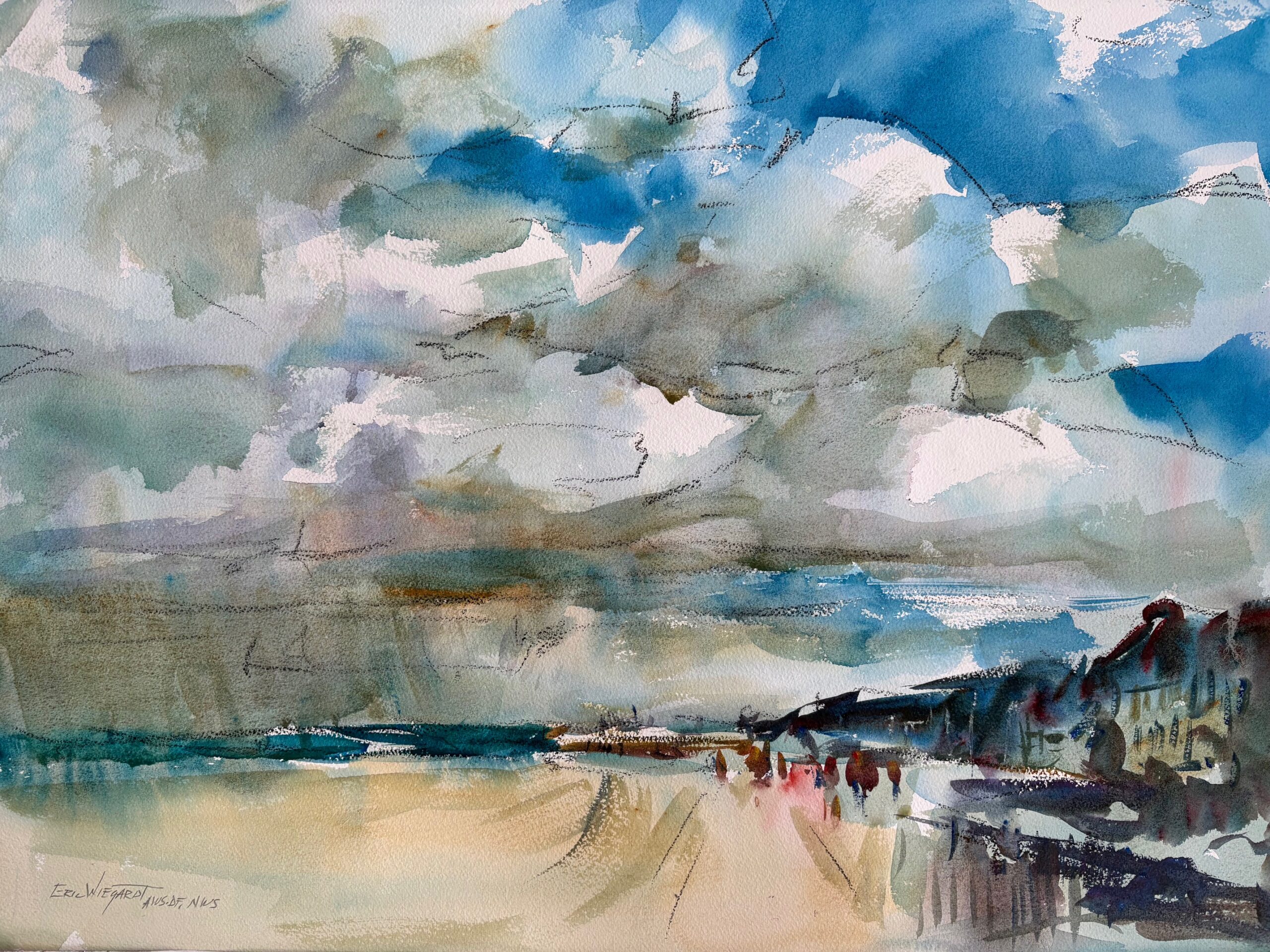 A wide beach under a dramatic sky filled with layered blue, gray, and white clouds. Small figures walk along pale sand toward distant buildings at the right, with a strip of teal sea on the horizon.