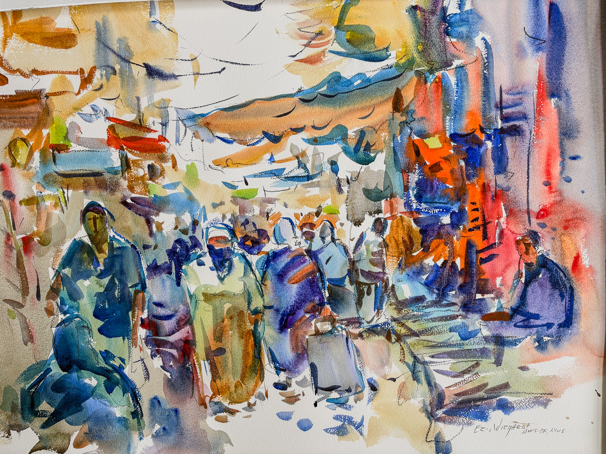A bustling outdoor market scene in loose watercolor. Figures in blues, purples, and earth tones walk down a crowded lane beneath tan awnings, with vivid orange and red stalls glowing along the right side.