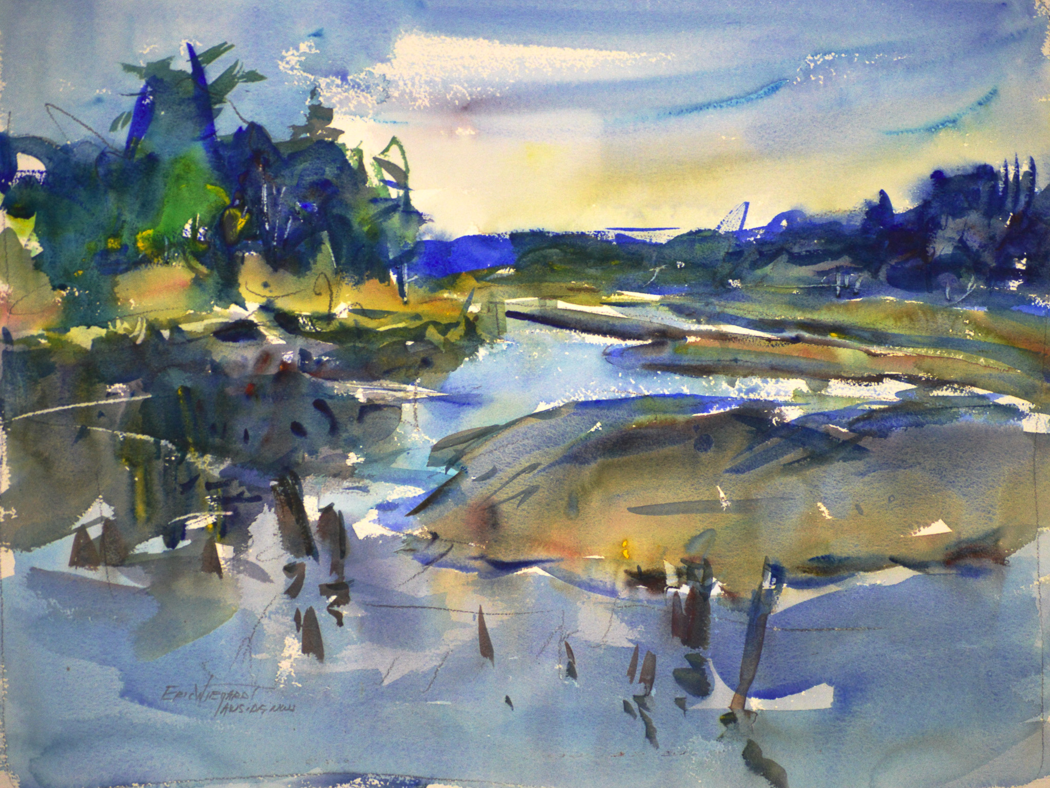 A tidal estuary at low water, where tan and olive sandbars curve through pale blue channels. Dark blue-green trees line the far bank beneath a soft yellow and blue sky, and weathered pilings stand scattered across the shallow foreground.